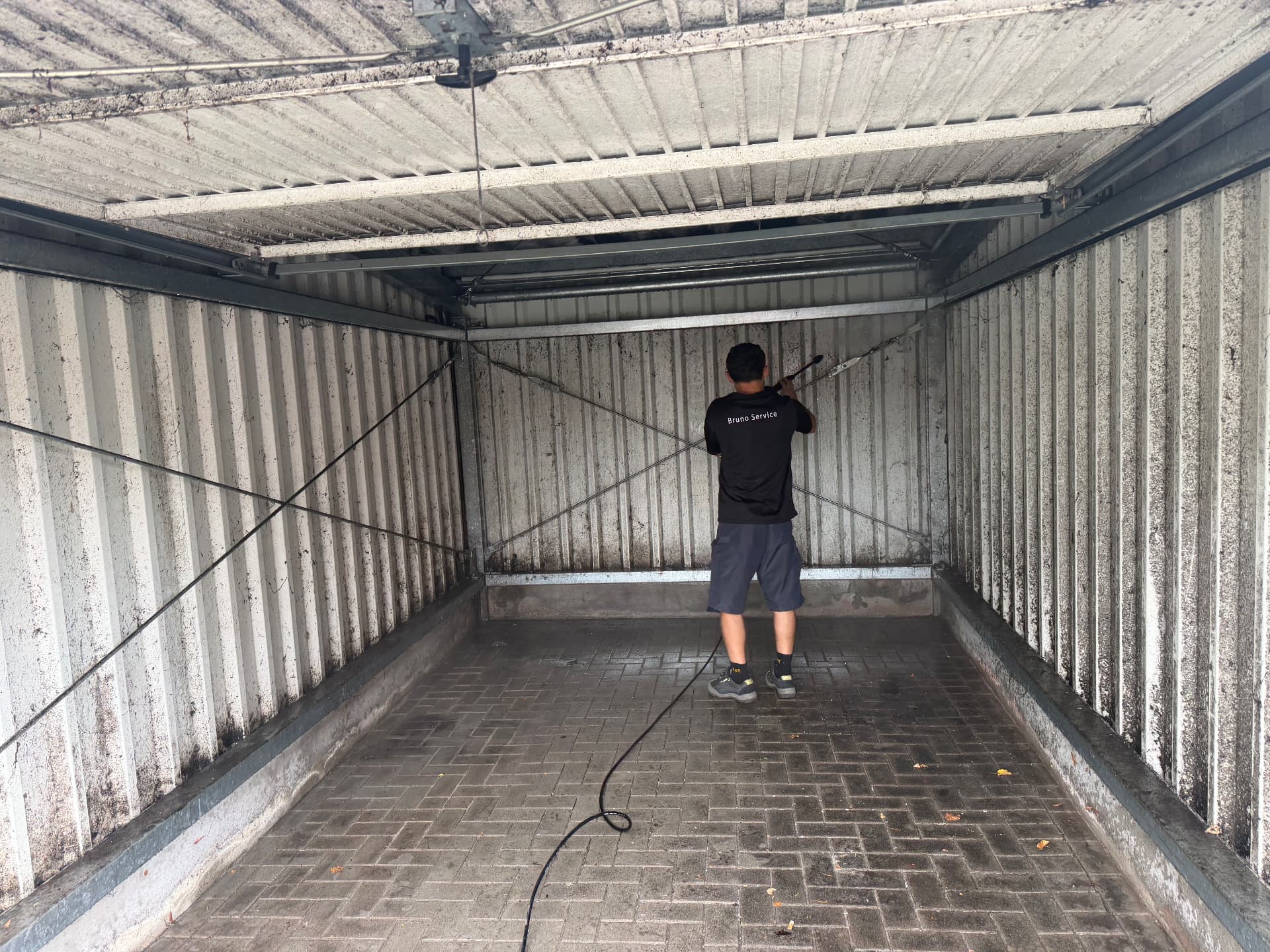 Garage wird mit dem Hochdruckreiniger gereinigt